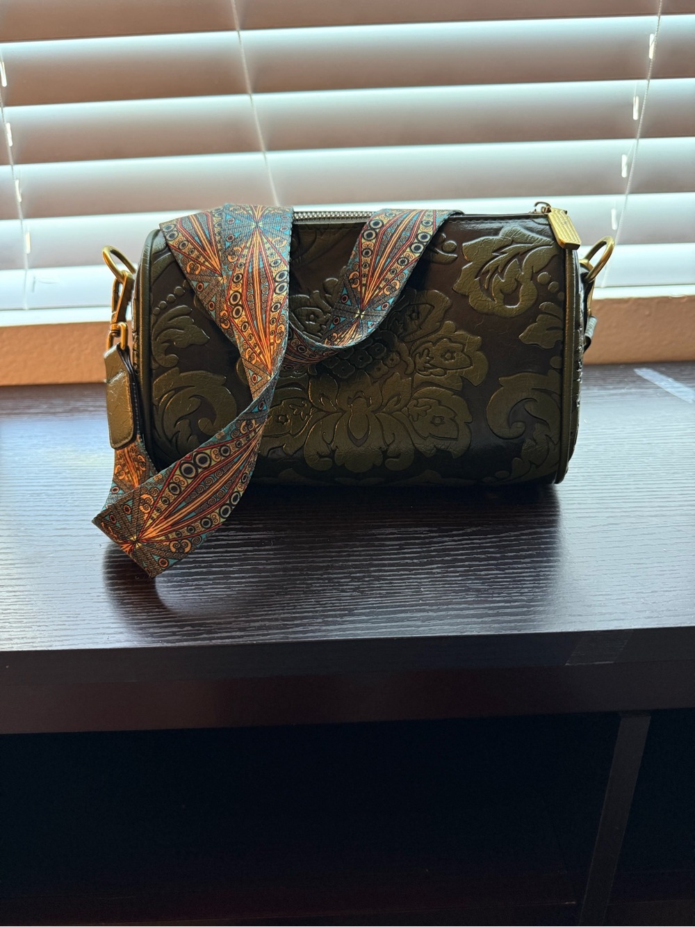 Embossed Olive Green Barrel Crossbody Bag with Patterned Strap